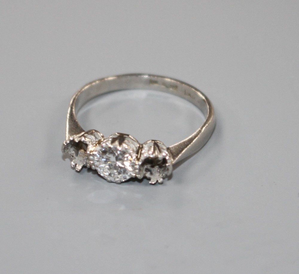A white metal and single stone (ex three stone) diamond ring,
